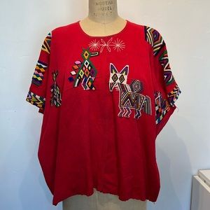 Vintage huipil from mexico with animals and geometric embroidery